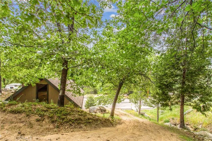 one of the dirt driveways leading to the house, facing the two car garage