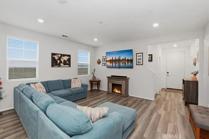 Living Room - “Digitally Altered Image by adding an image on the TV and a fire to the electric fireplace furniture piece"
