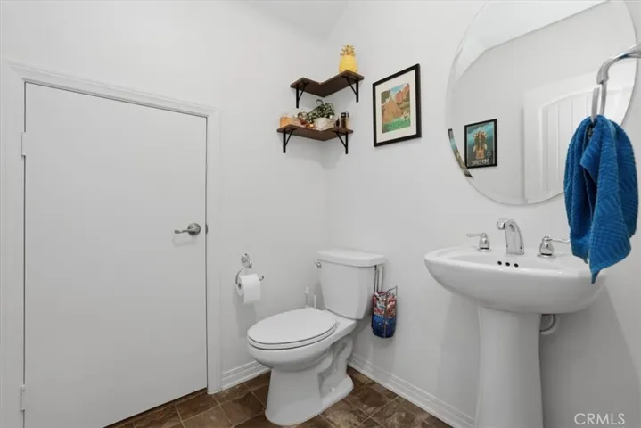 Downstairs Powder Room Bathroom with access to large under stairs storage