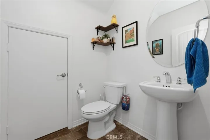 Downstairs Powder Room Bathroom with access to large under stairs storage