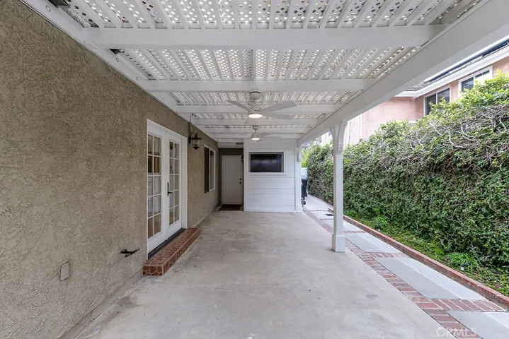 Side Patio Off Of Kitchen With TV & Fan