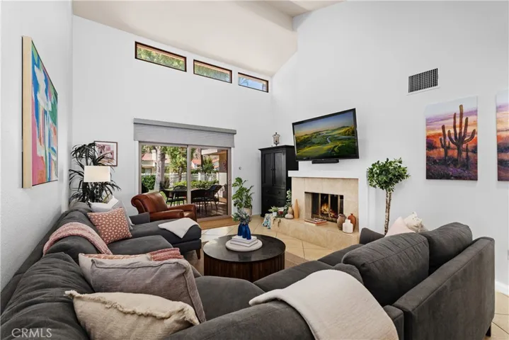Living room with vaulted ceiling, cozy fireplace and stunning mountain views.