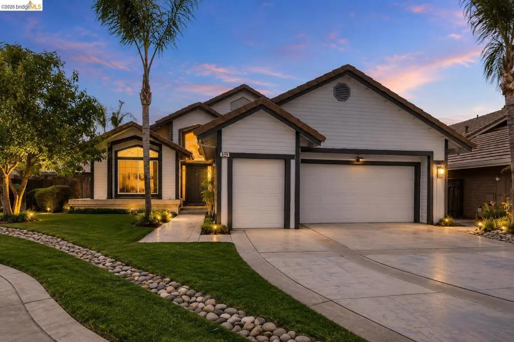 Modern exterior with white siding and dark trim
