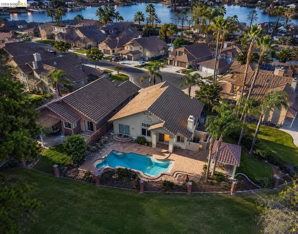Mediterranean-style residence featuring a private backyard with a freeform swimming pool and integrated spa
