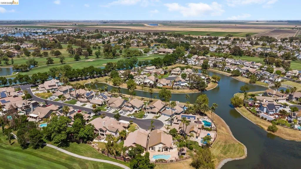 Aerial view of property and surrounding area with nearby suburban area