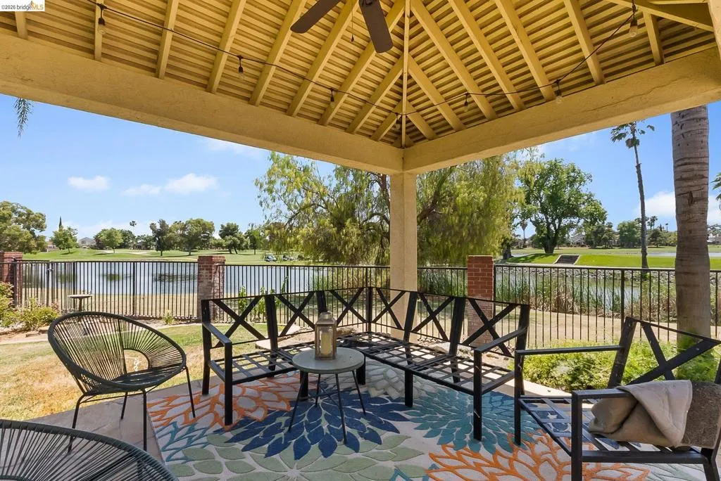 View of patio with a water view and a gazebo