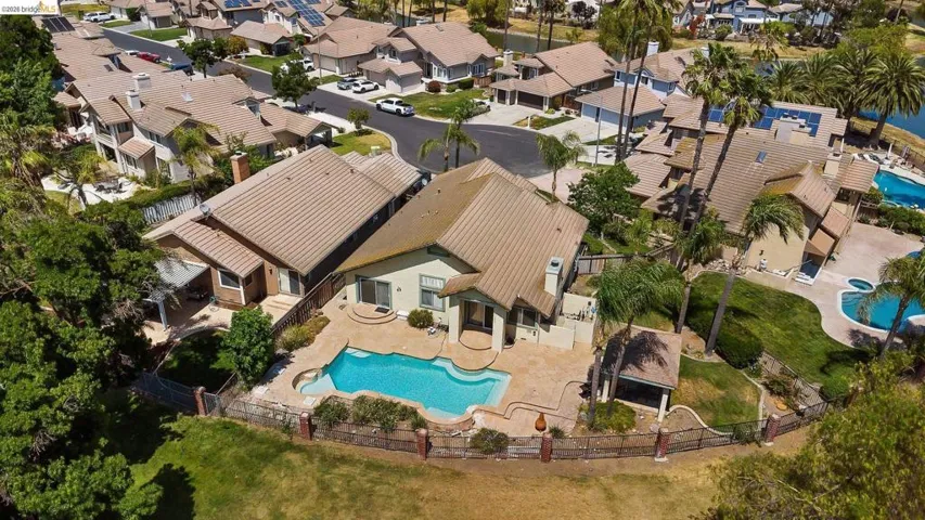 Aerial view of property and surrounding area with nearby suburban area