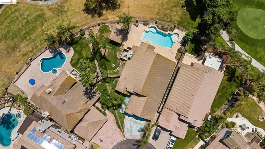Aerial overview of property's location featuring a pool area