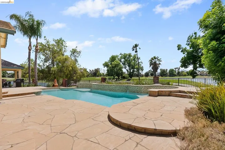 View of swimming pool featuring a patio area and a fenced backyard