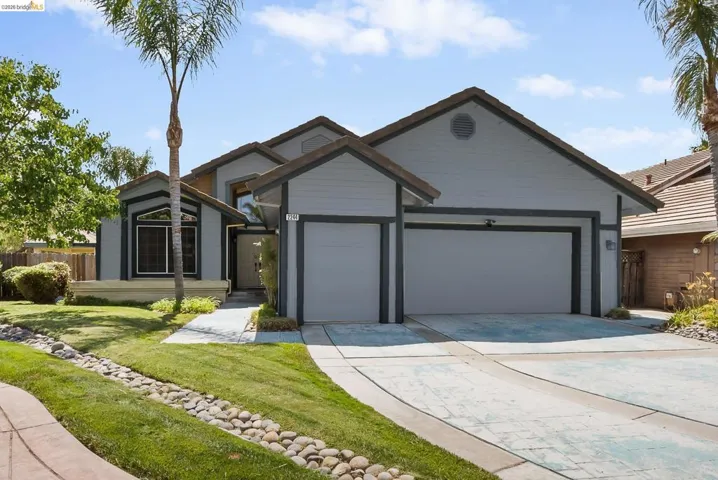Ranch-style house featuring an attached garage and driveway