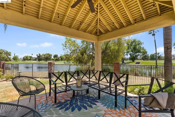 View of patio with a water view and a gazebo