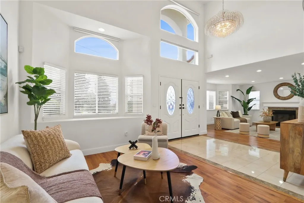 Formal Living Room with two-story high ceilings and Hunter Douglas automatic roll down shades