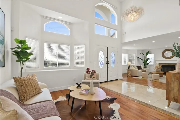 Formal Living Room with two-story high ceilings and Hunter Douglas automatic roll down shades