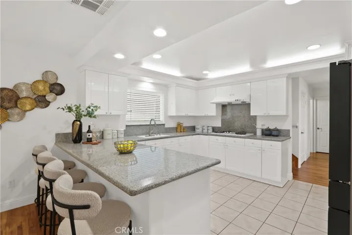 Granite countertops with full backsplash behind the stovetop