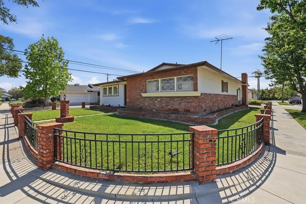 Wrought iron and brick fencing around corner lot home