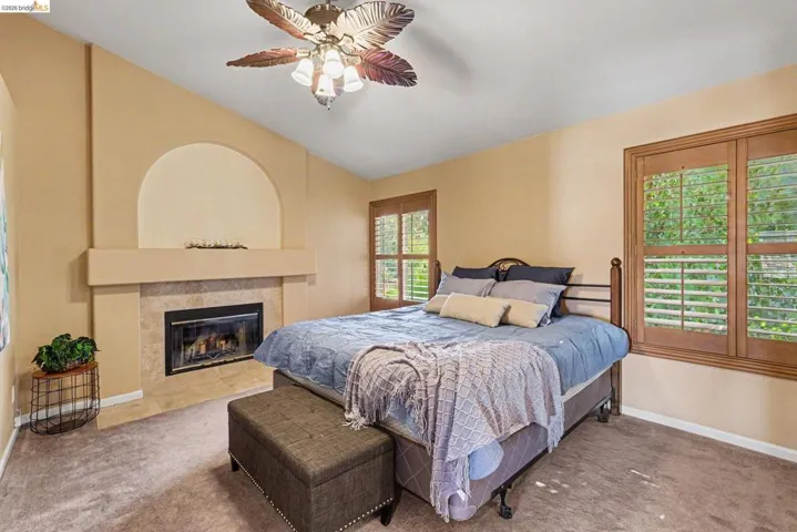 Room featuring a vaulted ceiling and a ceiling fan
