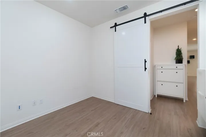 A chic sliding barn door opens to a convenient main level flex room adjacent to the bathroom, making it perfect as your home office or 4th bedroom
