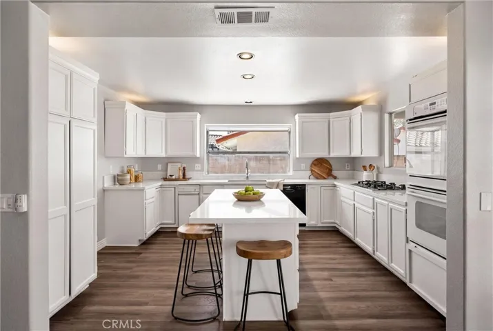 Kitchen with island virtually staged