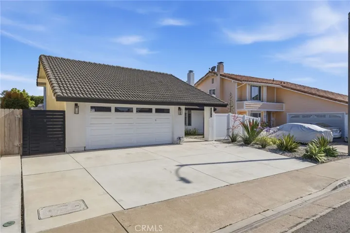 Front with newer poured concrete driveway for 3 cars
