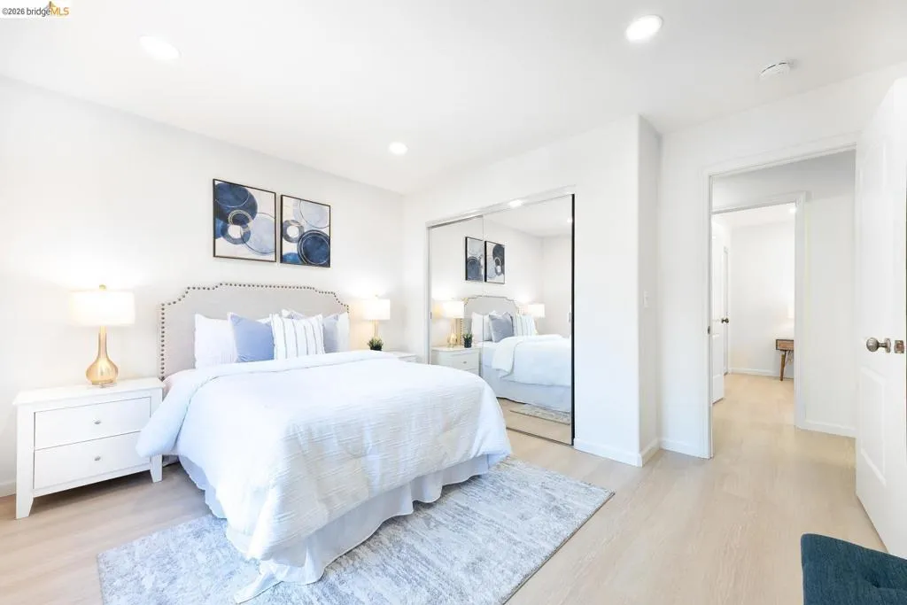 Bedroom featuring light wood-finish flooring, recessed lighting, and a mirrored closet door