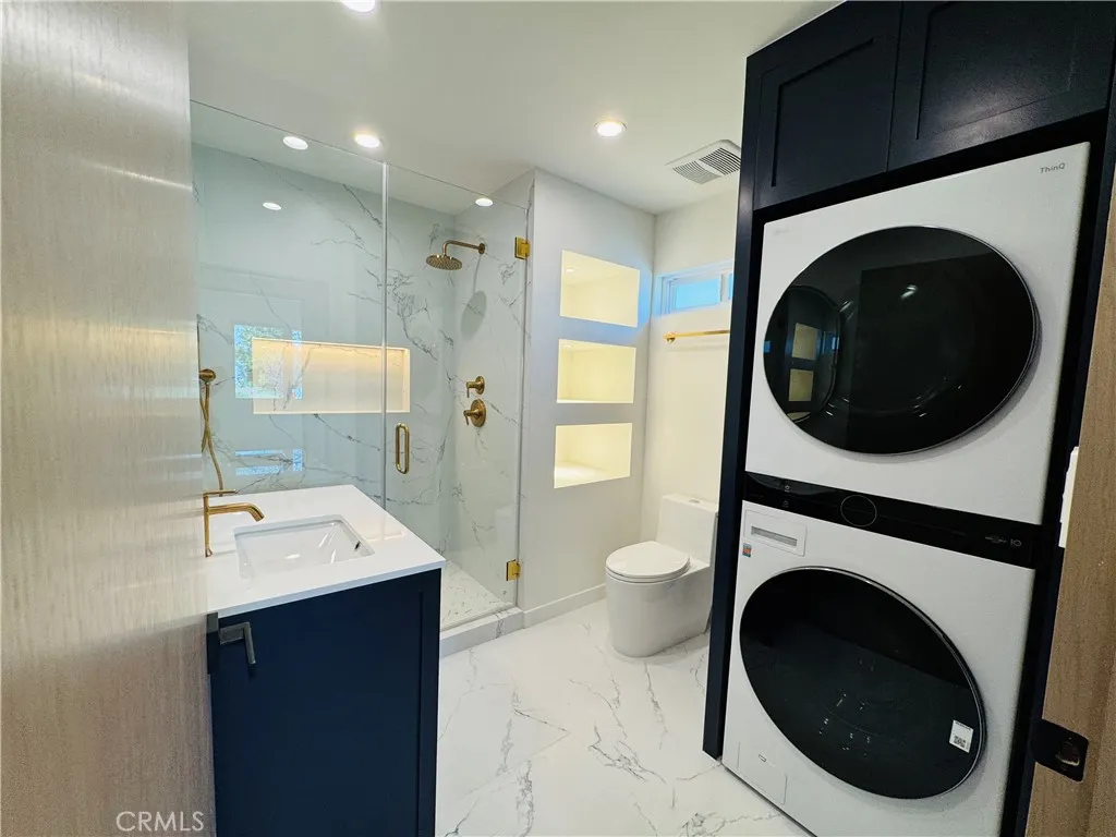 Gorgeous bathroom with all new standing shower, storage shelves with lights, and linen closet