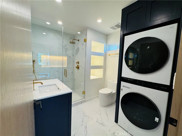 Gorgeous bathroom with all new standing shower, storage shelves with lights, and linen closet