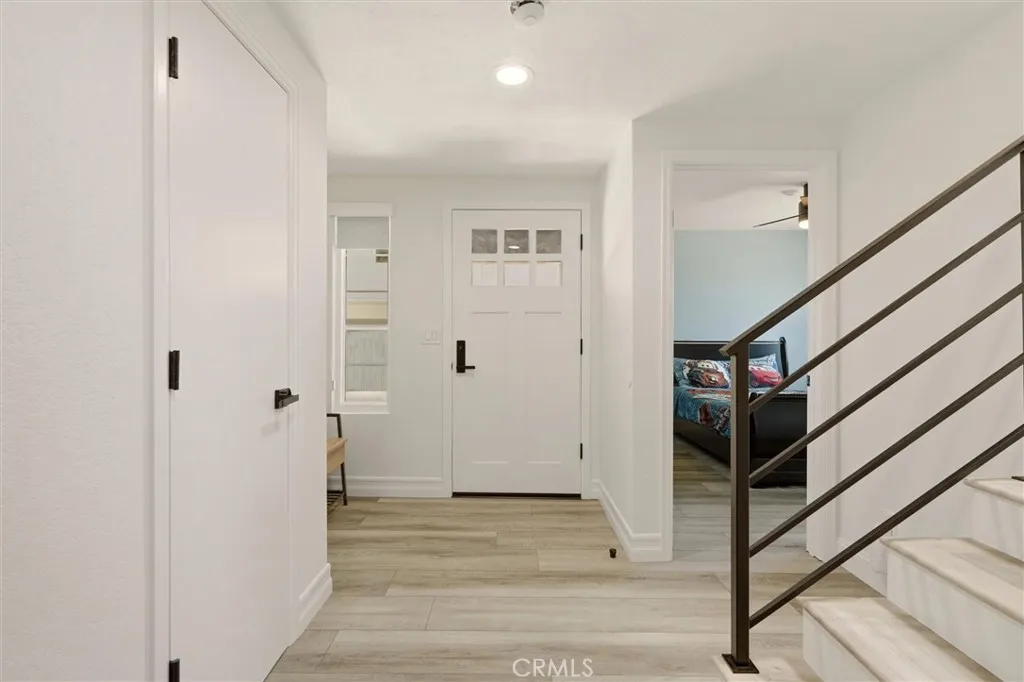 Downstairs hallway facing West towards the door