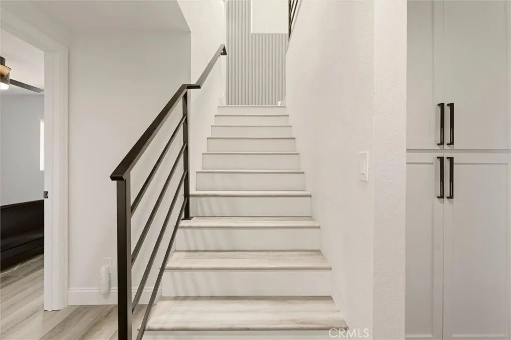 Stairs with iron railings leading to second floor