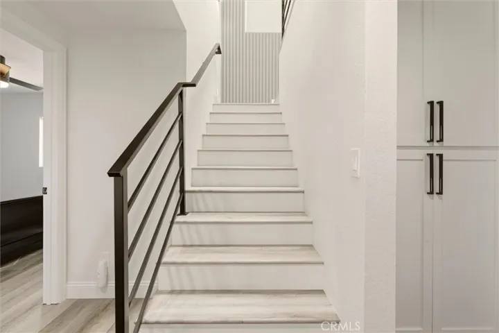 Stairs with iron railings leading to second floor