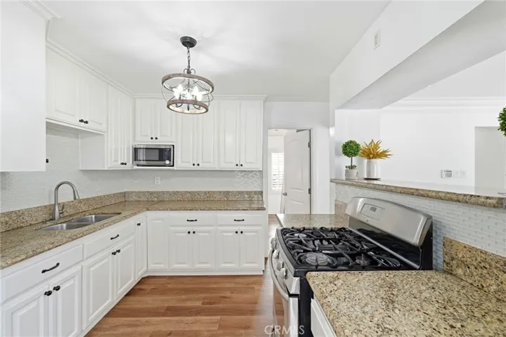 Granite countertops, custom white cabinetry, and premium stainless-steel appliances