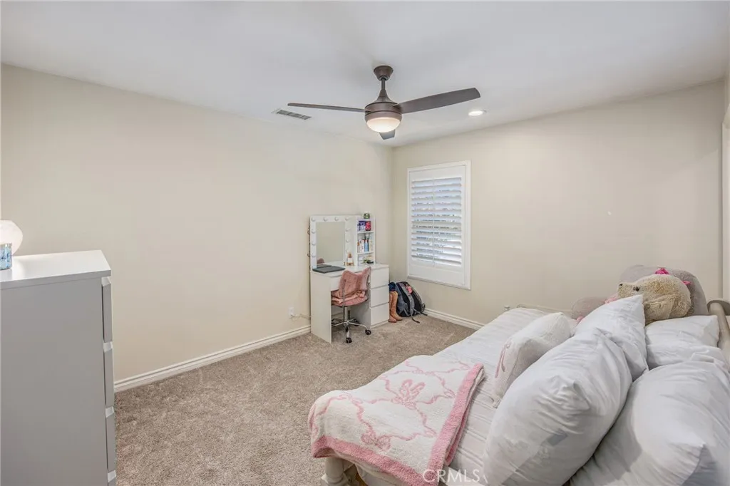 Secondary bedroom with a clean, comfortable design and natural light