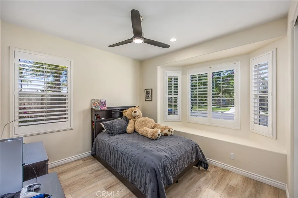 Convenient downstairs bedroom with plantation shutters and a charming window seat overlooking the front yard