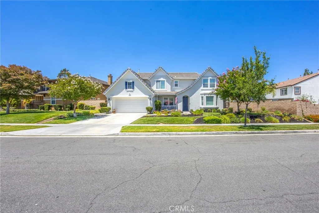 Beautiful curb appeal with manicured landscaping and a welcoming front elevation