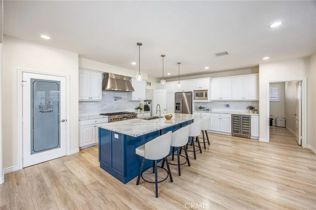 Remodeled kitchen featuring an oversized center island and an open layout designed for gathering and entertaining.
