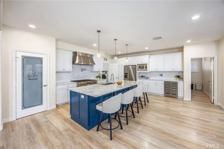 Remodeled kitchen featuring an oversized center island and an open layout designed for gathering and entertaining.