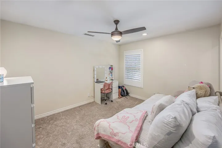 Secondary bedroom with a clean, comfortable design and natural light