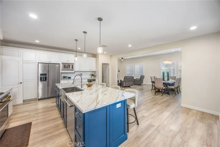 Open-concept gourmet kitchen that flows effortlessly into the living and dining areas