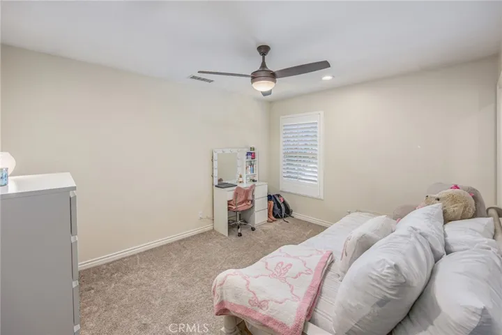Secondary bedroom with a clean, comfortable design and natural light