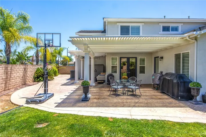 Spacious backyard with a large lawn and covered patio