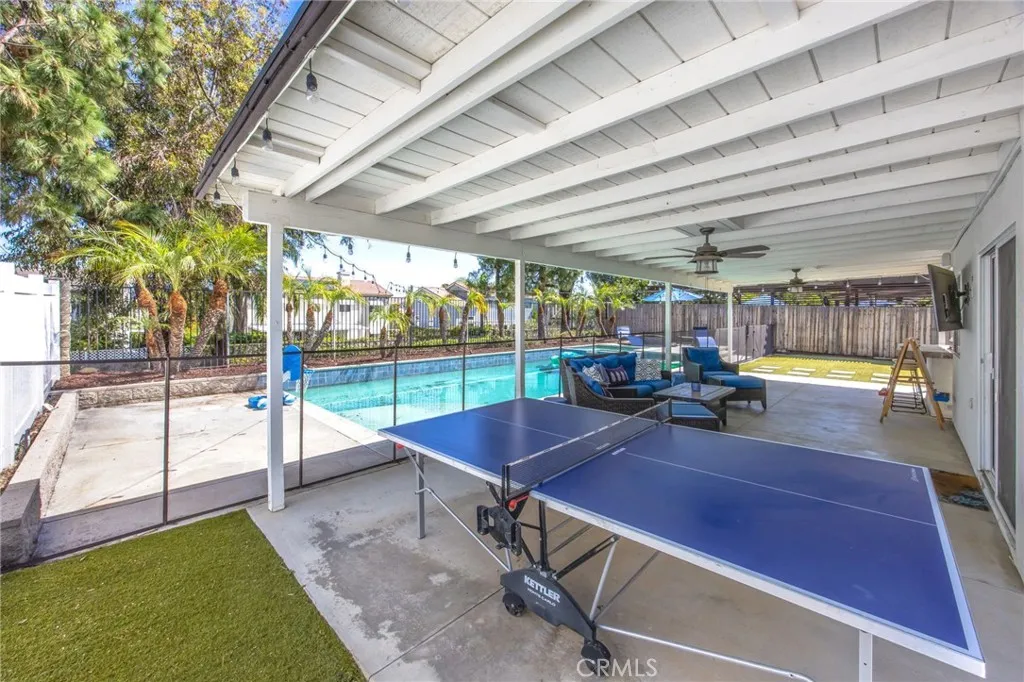 Covered patio spans the length of the home, creating an expansive outdoor living area