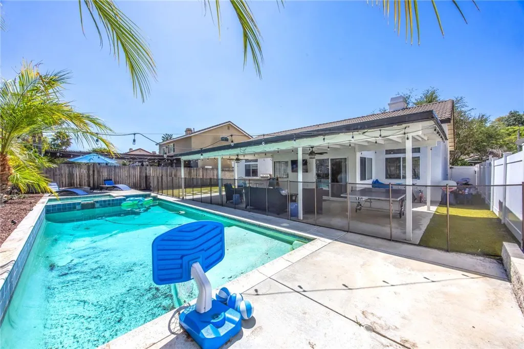 Fenced pool and spa area designed for safety and convenience