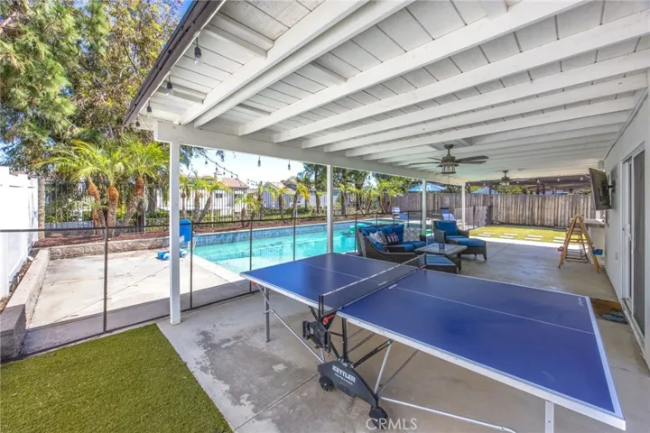 Covered patio spans the length of the home, creating an expansive outdoor living area