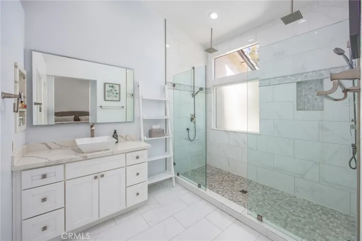 Updated primary bathroom with a spacious walk-in shower