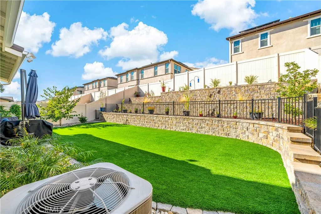 Oversized terraced back yard with artificial turf