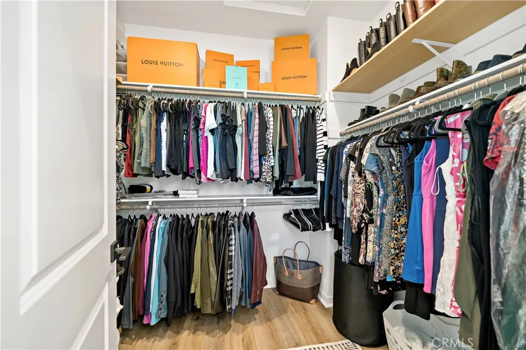 Owners Walk in closet with additional shelving