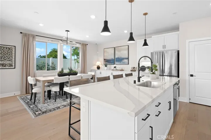 Front exterior photos are of the actual home. Back yard & interior photos are of the builder’s model home with the same floor plan and are for illustrative purposes only. Actual finishes, features, furnishings, and condition may vary. Home is under construction and will be delivered unfurnished.