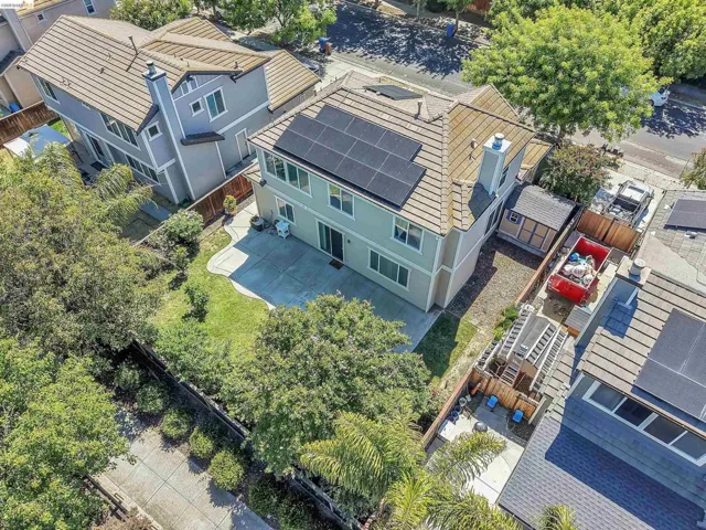 Two-story residence featuring a tile roof and solar panels