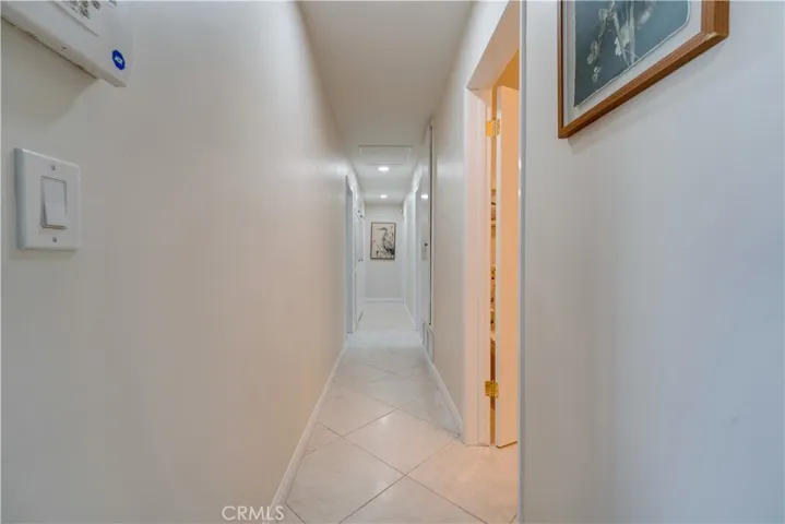 Hallway down to four bedrooms (including a primary suite and guest bathroom).