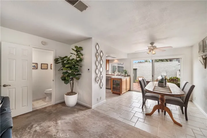 Travertine-style tile flooring in dining room and kitchen