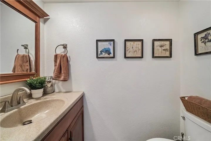 Half bath downstairs with newer vanity with Silestone-type countertop